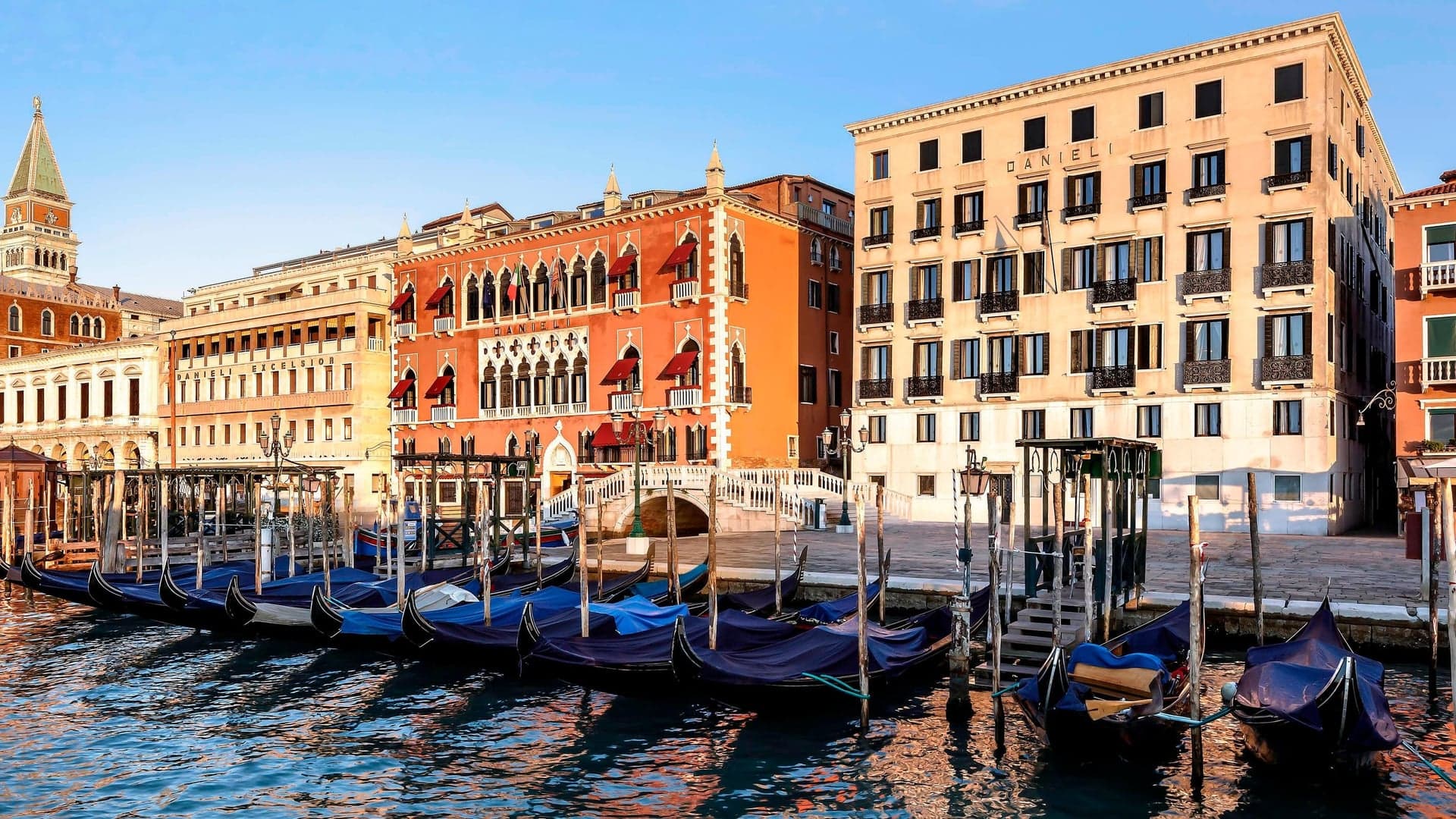 Hotel Danieli from an outside perspective with hits fine boats and colourful buildings at daytime