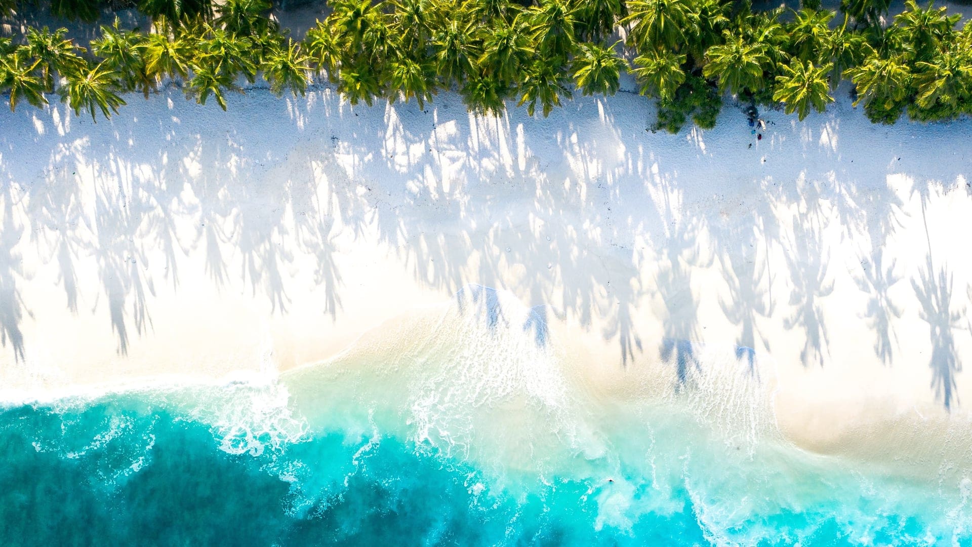 an empty beach with crystal clear water